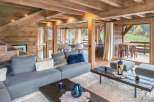 This stunning chalet boasts a spacious open-plan living area with floor-to-ceiling windows offering breathtaking views.