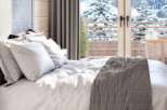 Wake up to breathtaking mountain views from this luxurious bedroom.