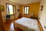 Cozy bedroom with natural light and wooden floors.