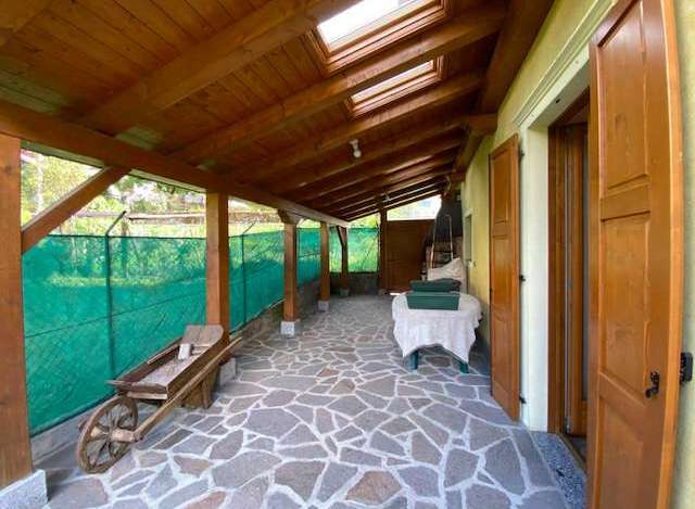 Discover a charming property with a unique covered patio, perfect for enjoying the outdoors in any weather.