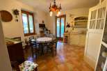 This charming kitchen features a cozy dining area with a round table, perfect for family meals.