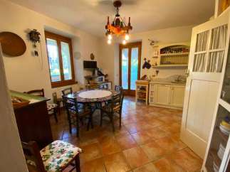 This charming kitchen features a cozy dining area with a round table, perfect for family meals.