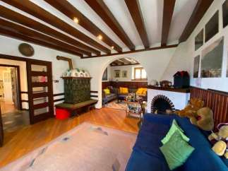 Step into a charming living space with a unique blend of rustic and elegant design.