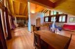 This stunning property boasts a spacious, light-filled interior with exposed wooden beams and a warm, inviting atmosphere.
