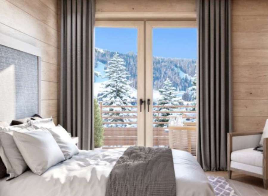 Wake up to breathtaking mountain views from this luxurious bedroom.