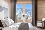 Wake up to breathtaking mountain views from this luxurious bedroom.