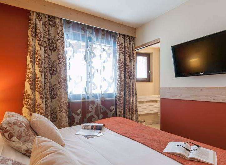 Cozy up in this inviting bedroom, featuring a comfortable bed and stylish decor.