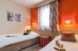 This cozy bedroom features two twin beds, perfect for a comfortable stay.