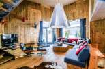 Experience rustic luxury in this stunning chalet-style living room.