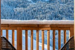 Enjoy breathtaking mountain views from this stunning balcony, complete with comfortable outdoor seating and a small table perfect for morning coffee.