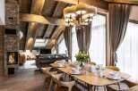 This stunning chalet boasts a spacious open-plan living area with a cozy fireplace, perfect for relaxing after a day on the slopes.