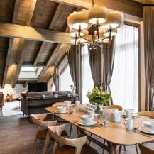 This stunning chalet boasts a spacious open-plan living area with a cozy fireplace, perfect for relaxing after a day on the slopes.