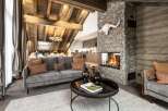 This stunning chalet boasts a spacious open-plan living area with a cozy fireplace, perfect for relaxing after a day on the slopes.