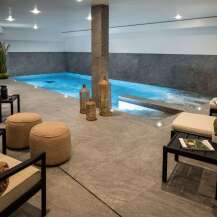 Indulge in the ultimate relaxation experience in this luxurious indoor pool and spa area.