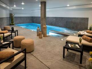 Indulge in the ultimate relaxation experience in this luxurious indoor pool and spa area.