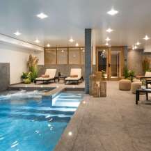 Indulge in the ultimate relaxation experience at this luxurious property, featuring a stunning indoor pool and spa area.