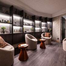Relax in our luxurious spa, featuring plush seating areas and uniquely designed shelves stocked with premium skincare products.