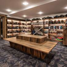 This ski rental shop boasts ample shelving for helmets, goggles, and other gear, with a modern, rustic design.