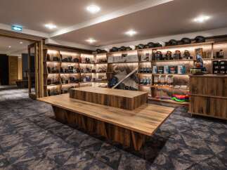 This ski rental shop boasts ample shelving for helmets, goggles, and other gear, with a modern, rustic design.