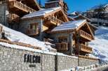 Nestled in a snow-covered mountainside, Falcon Megève offers luxurious chalets with stunning wooden balconies and stone exteriors.