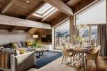 This stunning chalet boasts a spacious open-plan living area with floor-to-ceiling windows offering breathtaking mountain views.
