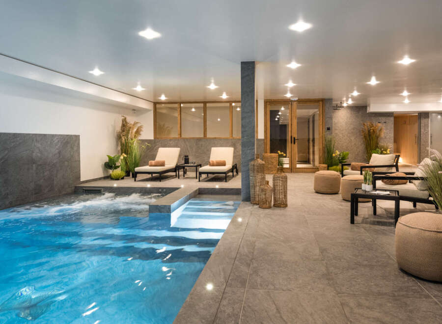 Indulge in the ultimate relaxation experience at this stunning property, featuring a luxurious indoor pool and spa area.