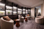 Relax in style at our luxurious spa, featuring plush seating areas and uniquely designed shelves showcasing our premium skincare products.