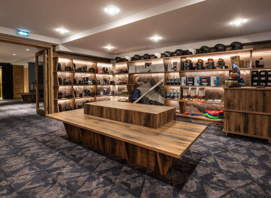This ski shop boasts ample shelving for equipment and accessories, a spacious layout, and a modern design.