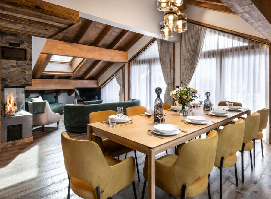 This stunning chalet boasts a spacious open-plan living area with a cozy fireplace, perfect for relaxing after a day on the slopes.
