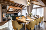 This stunning chalet boasts a spacious open-plan living area with a cozy fireplace, perfect for relaxing after a day on the slopes.