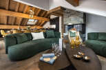 This luxurious chalet boasts a spacious open-plan living area with a stunning fireplace, perfect for cozy evenings.