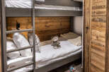 Cozy bunk beds nestled in a rustic wooden room, perfect for a family getaway.