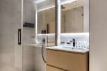 Step into a modern bathroom oasis, featuring a sleek glass-enclosed shower and a stylish floating vanity.