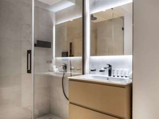 Step into a modern bathroom oasis, featuring a sleek glass-enclosed shower and a stylish floating vanity.