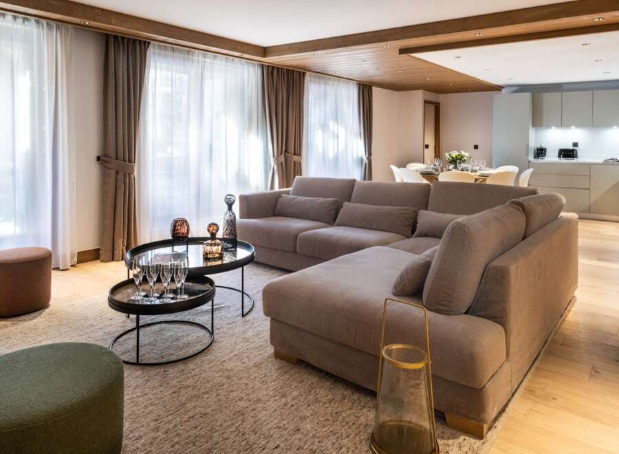 Experience luxury living in this stunning property, featuring a spacious living room with a comfortable sectional sofa, perfect for relaxation.