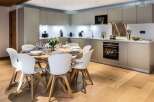 This stunning kitchen and dining area is the heart of the home, featuring modern cabinetry and a sleek design.
