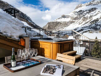 Luxury chalet with a private rooftop terrace boasting a hot tub and breathtaking mountain views.