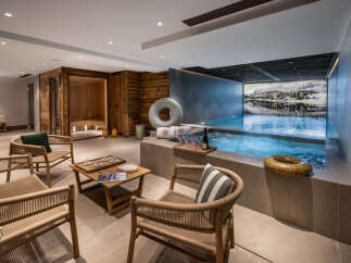 This luxurious property boasts a stunning indoor pool and hot tub area, complete with a relaxing sauna and comfortable seating.