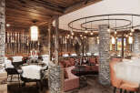 This stunning restaurant boasts a unique blend of rustic charm and modern elegance, featuring a cozy seating area with plush cushions and a stone fireplace.