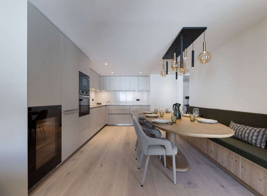 This modern kitchen and dining area offers a seamless blend of style and functionality.