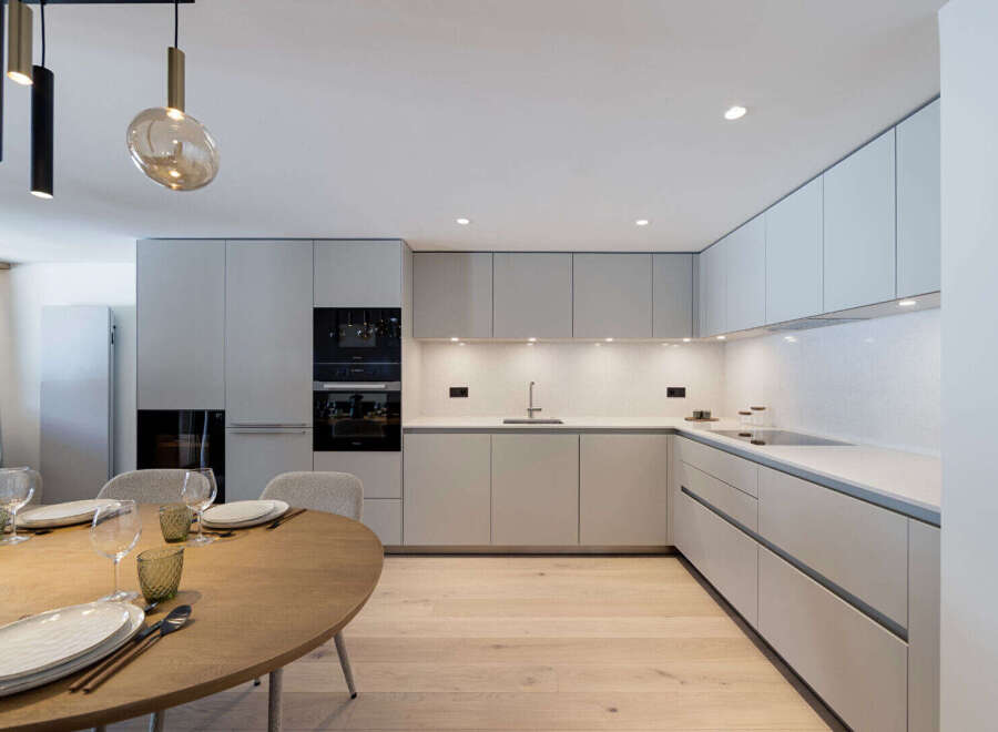 This modern kitchen features sleek cabinetry, stainless steel appliances, and a minimalist design.
