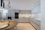 This modern kitchen features sleek cabinetry, stainless steel appliances, and a minimalist design.