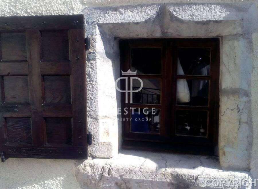 Discover the charm of this property with its rustic wooden window and shutter.