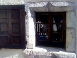 Discover the charm of this property with its rustic wooden window and shutter.