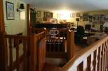 Discover the charm of this property, featuring a warm and inviting interior with wooden accents.