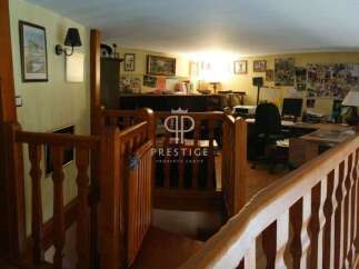 Discover the charm of this property, featuring a warm and inviting interior with wooden accents.