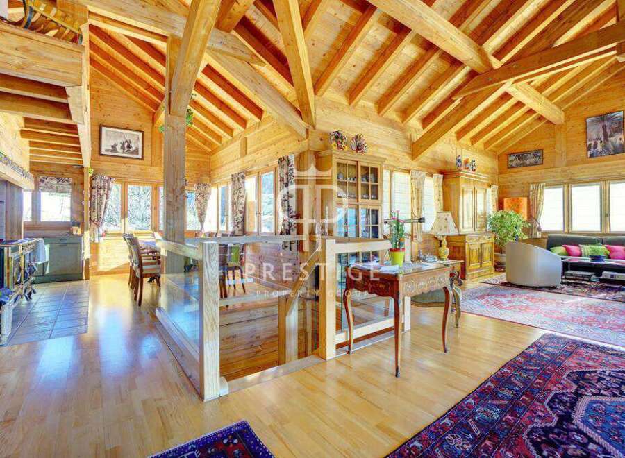 Experience the warmth of this stunning wooden chalet, featuring a spacious open-plan living area with exposed beams and natural light.