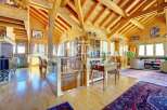 Experience the warmth of this stunning wooden chalet, featuring a spacious open-plan living area with exposed beams and natural light.