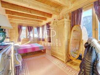 Discover the charm of this cozy bedroom, featuring a warm wooden interior and a touch of elegance.