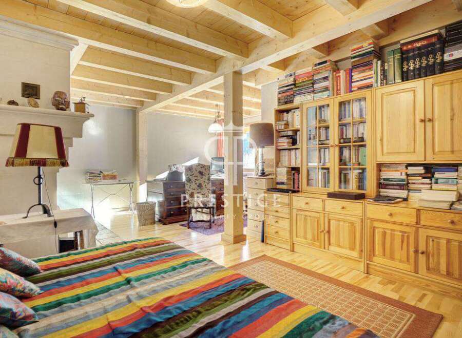 This charming property boasts a cozy bedroom with a vibrant, striped bedspread.